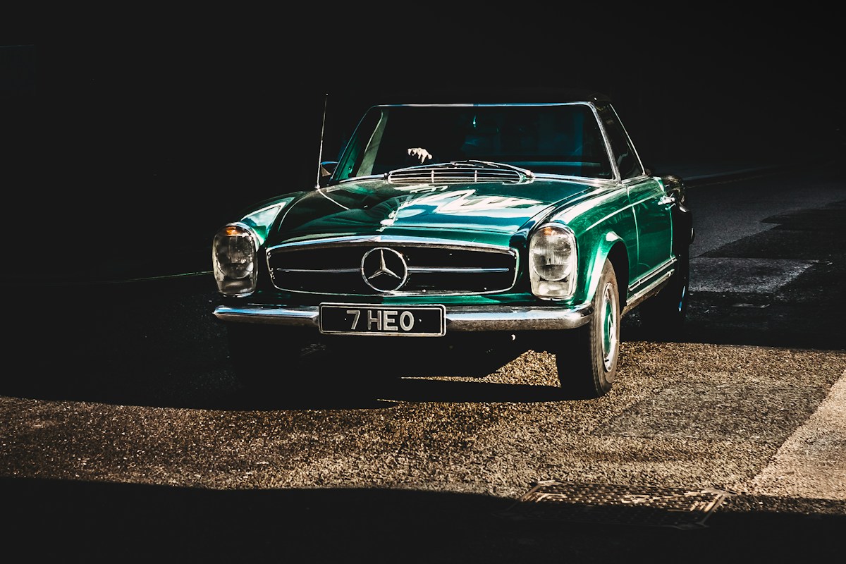 Green classic car viewed from the side